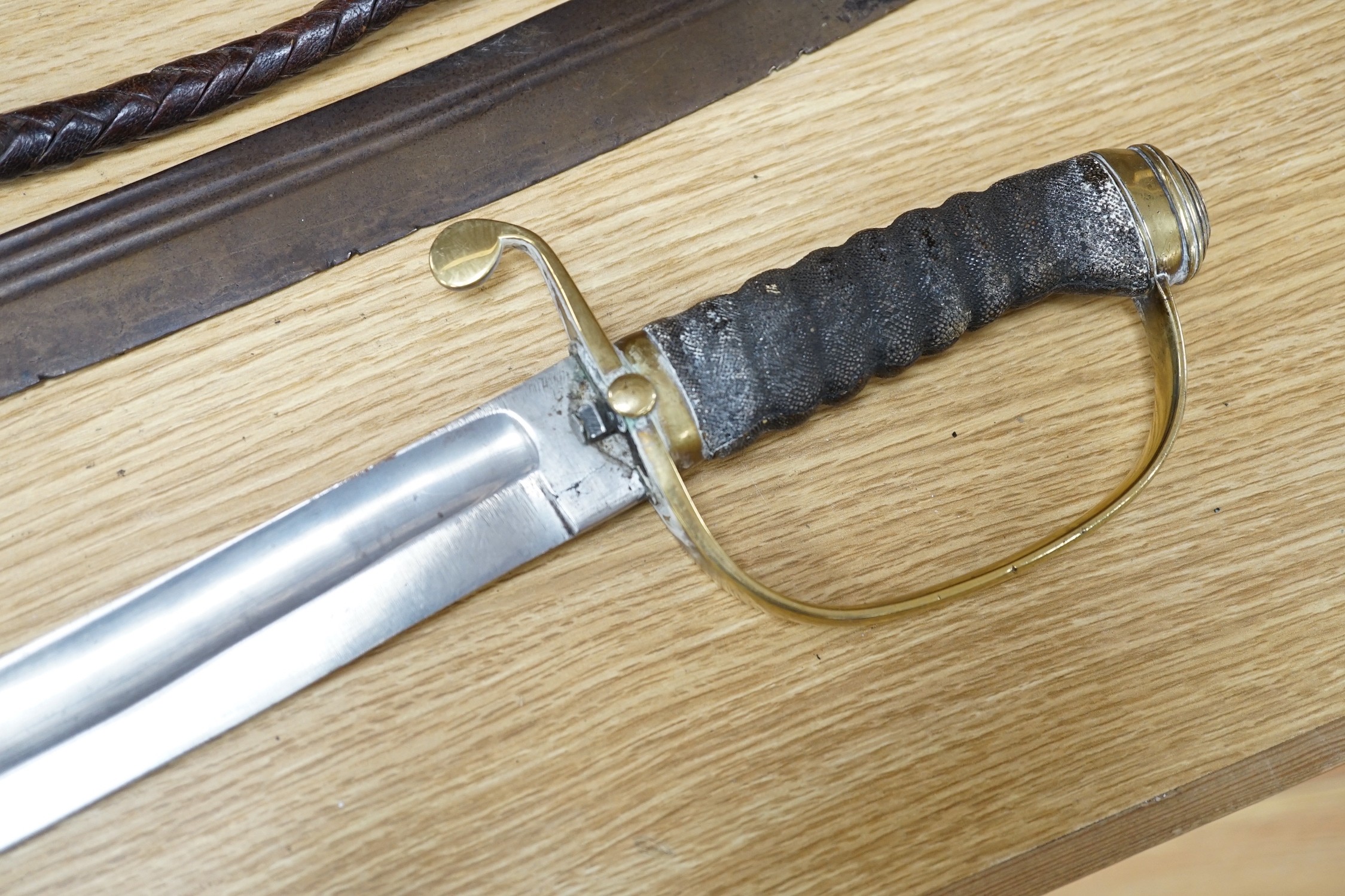 An Ottoman tulwar sabre, a European sabre and a leather whip